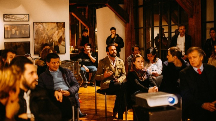 Engaged audience at an intimate community event, reflecting the creator economy shift toward local connection and real-world gatherings