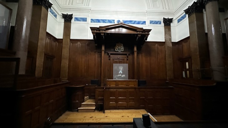 Empty courtroom with wooden paneling where social media addiction lawsuits are heard