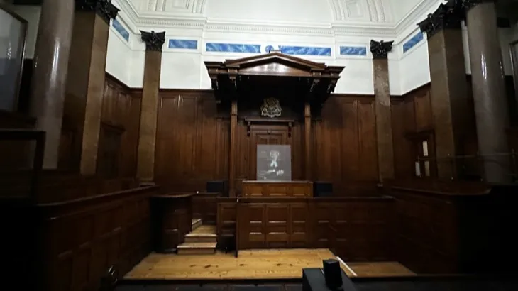 Empty courtroom with wooden paneling where social media addiction lawsuits are heard