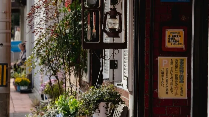 Charming local storefront with plants and vintage signage, representing small business community character