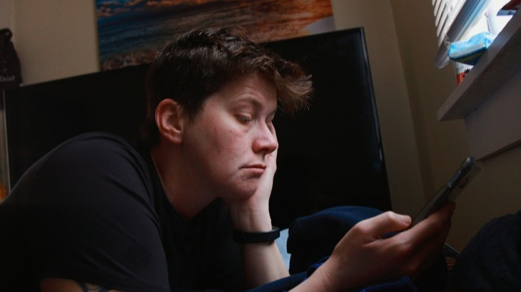 Person casually holding a smartphone, representing authentic unfiltered content creation